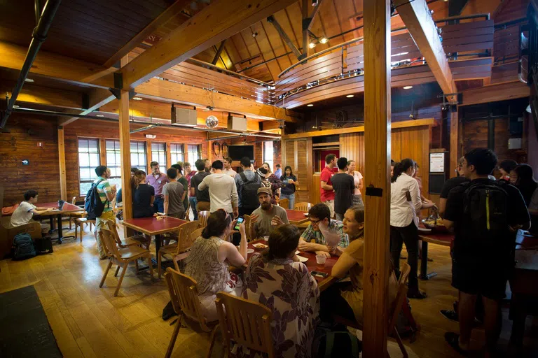 Graduate students enjoy a social event at the Big Red Barn's cafe.