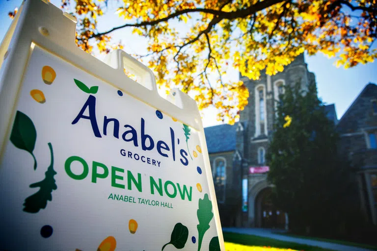 An "Open Now" sign for Anabel’s Grocery outside of Anabel Taylor Hall. 