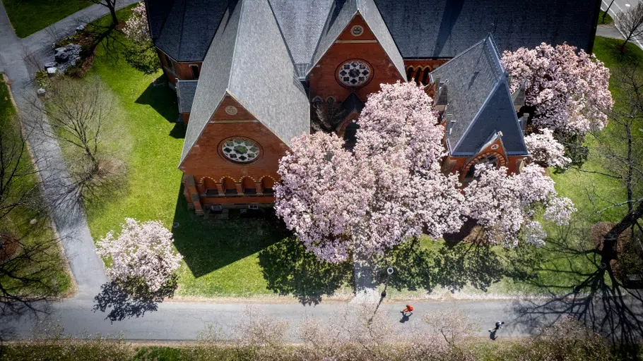 Sage Chapel as seen from overhead on a spring day, with trees displaying pink blossoms.