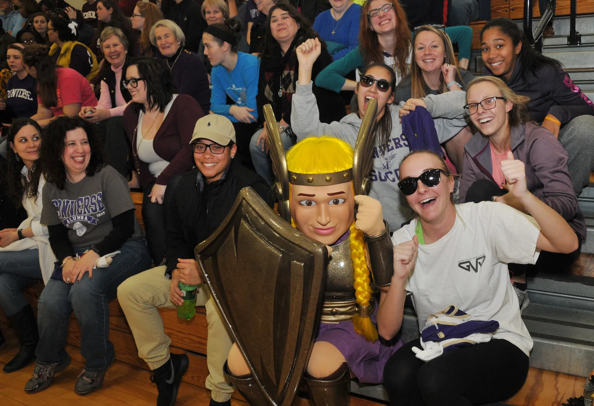 Fans cheer in the bleachers with the Converse Valkyrie Mascot.