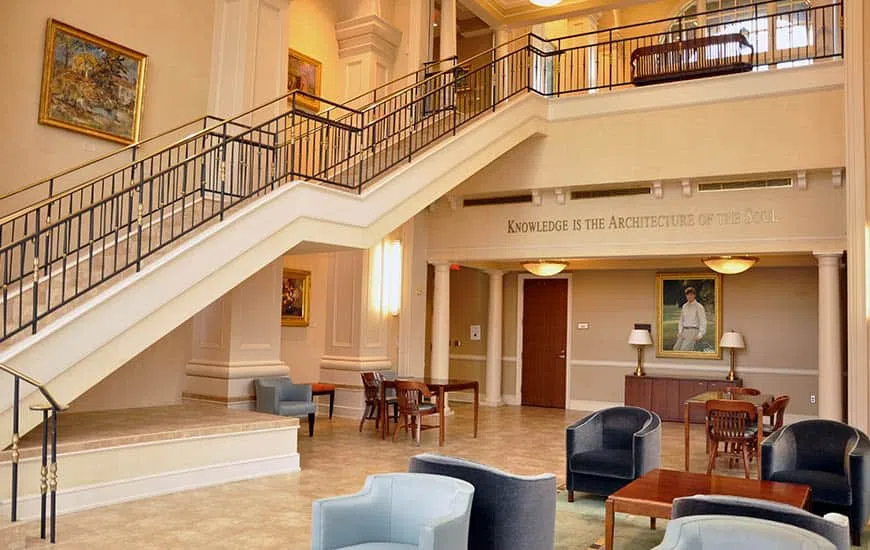A spacious two-story lobby with a sweeping staircase on the left.