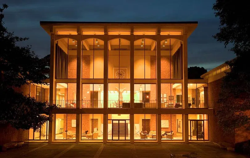 Looking into the two-story music hall from outside, lit up at night.