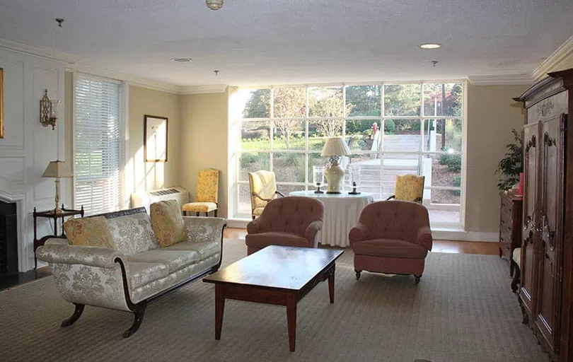 A sunny lounge area with sofa and sitting chairs