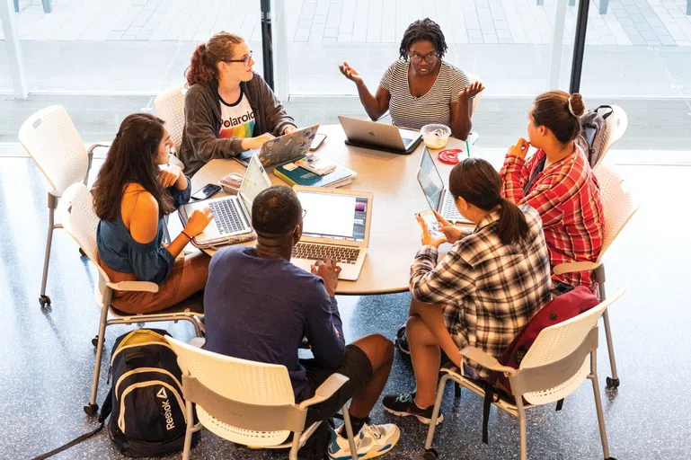 Students meet and talk around a round table