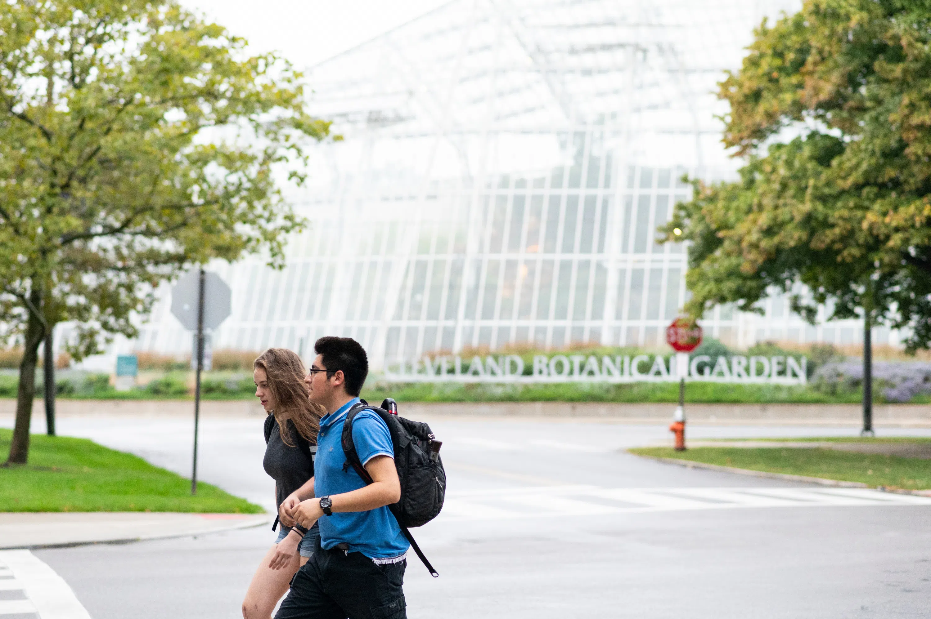 Two students walk in front of the Cleveland Botanical Garden