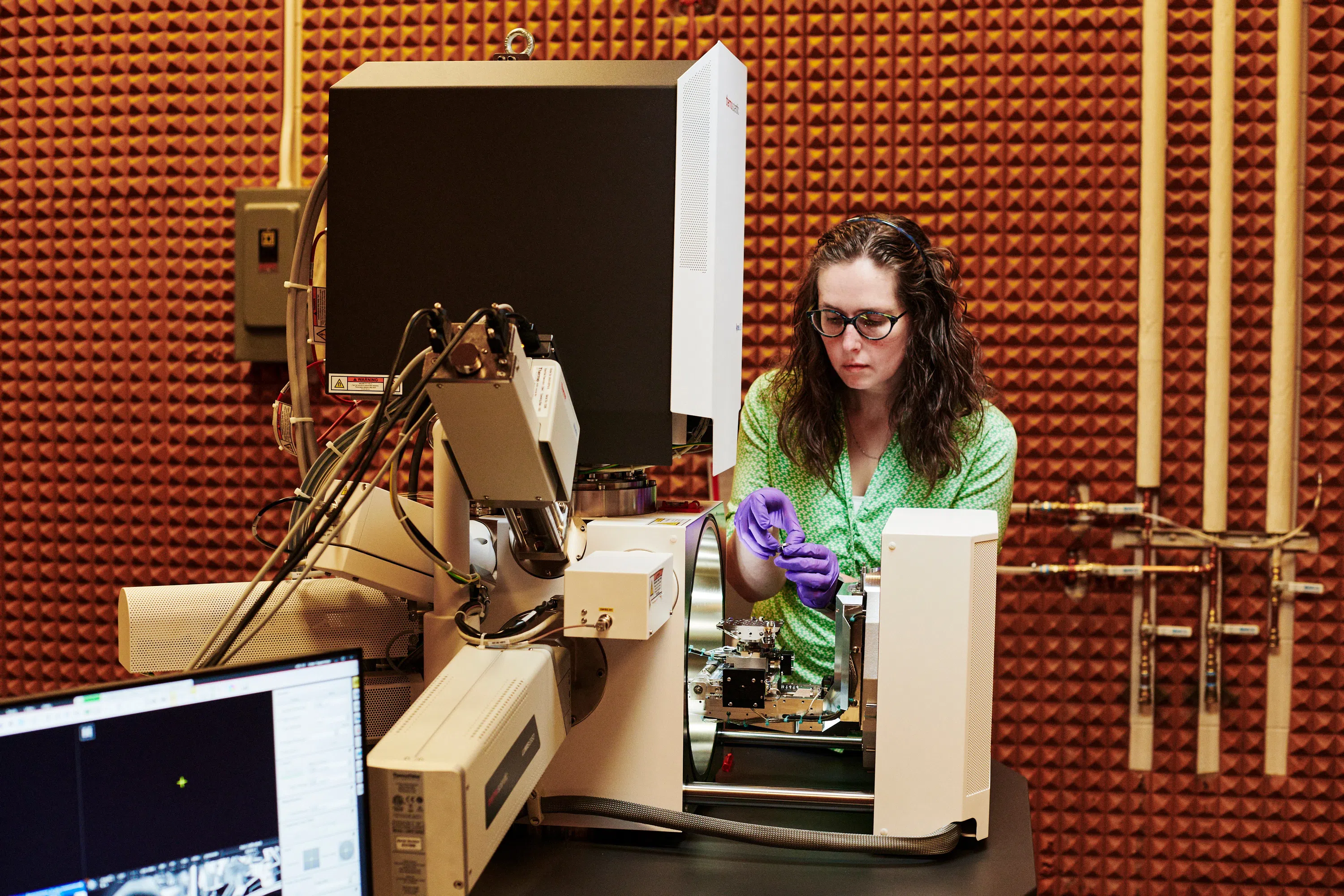 Student working on components of a large machine