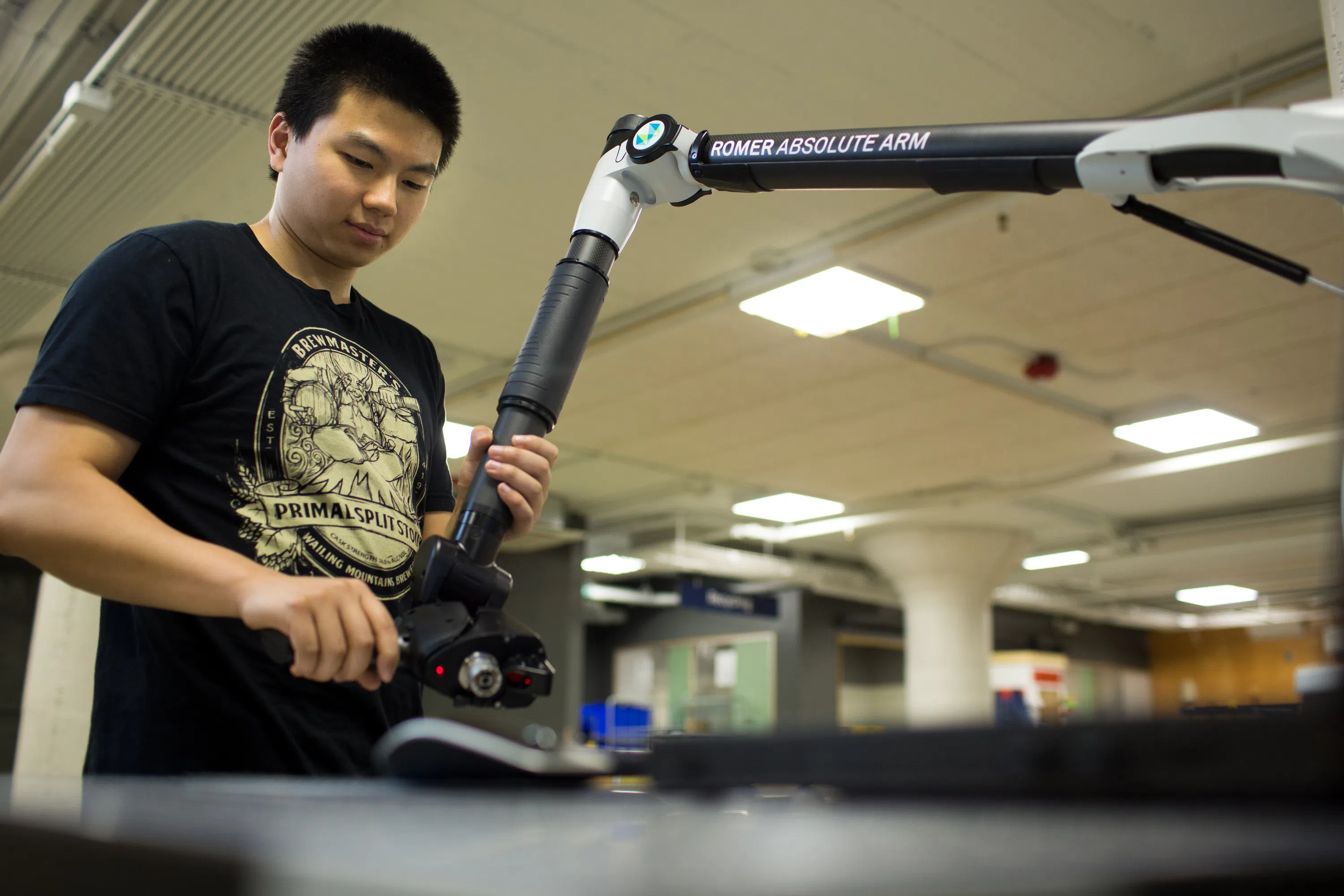 A student works with robotic arm technology