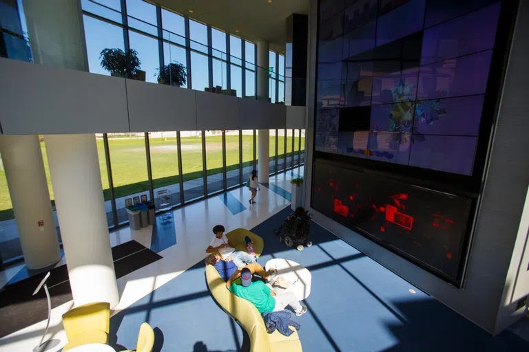 Looking down at two students sitting on couches inside the Tink.