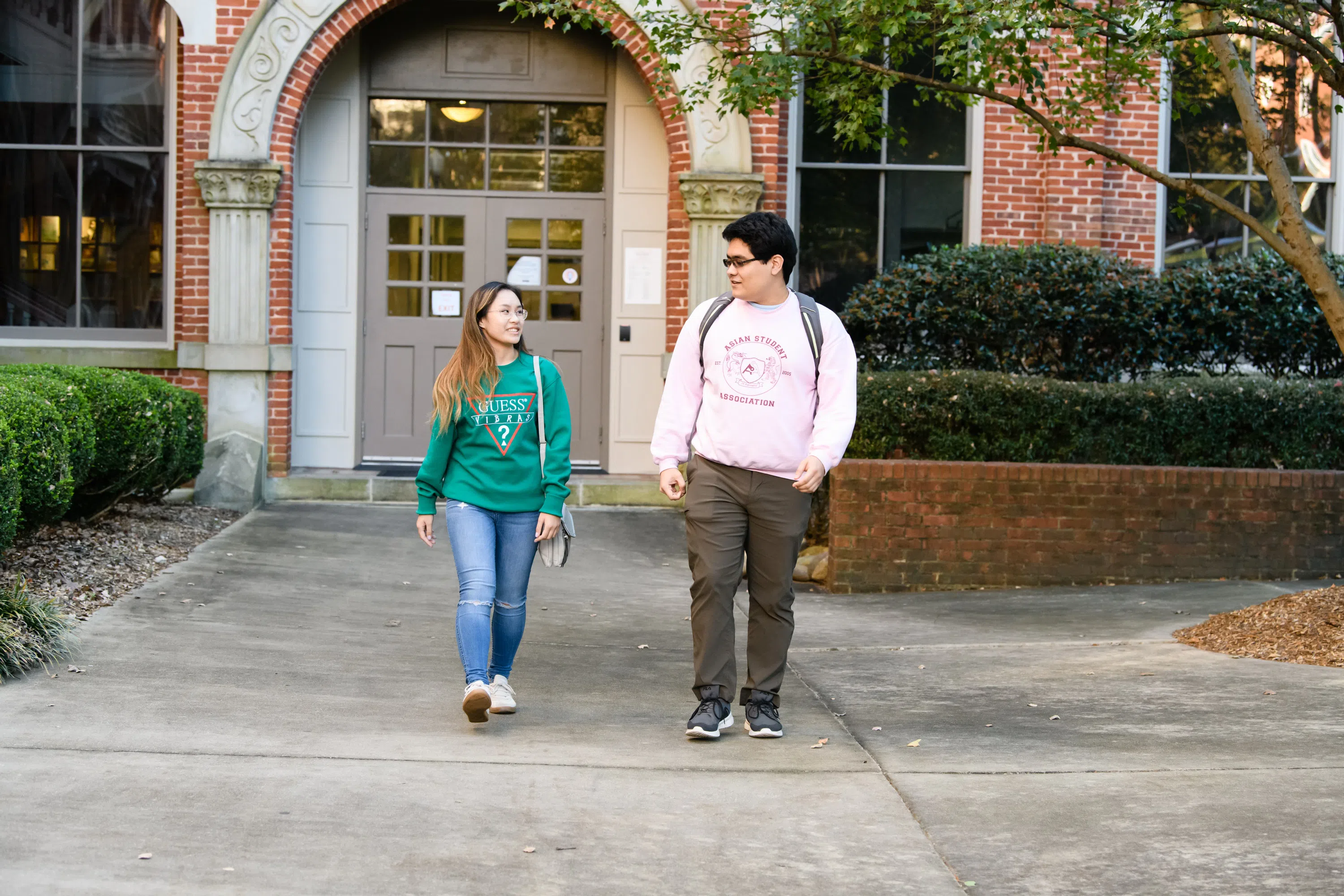 Two students walk outside Hardin Hall.