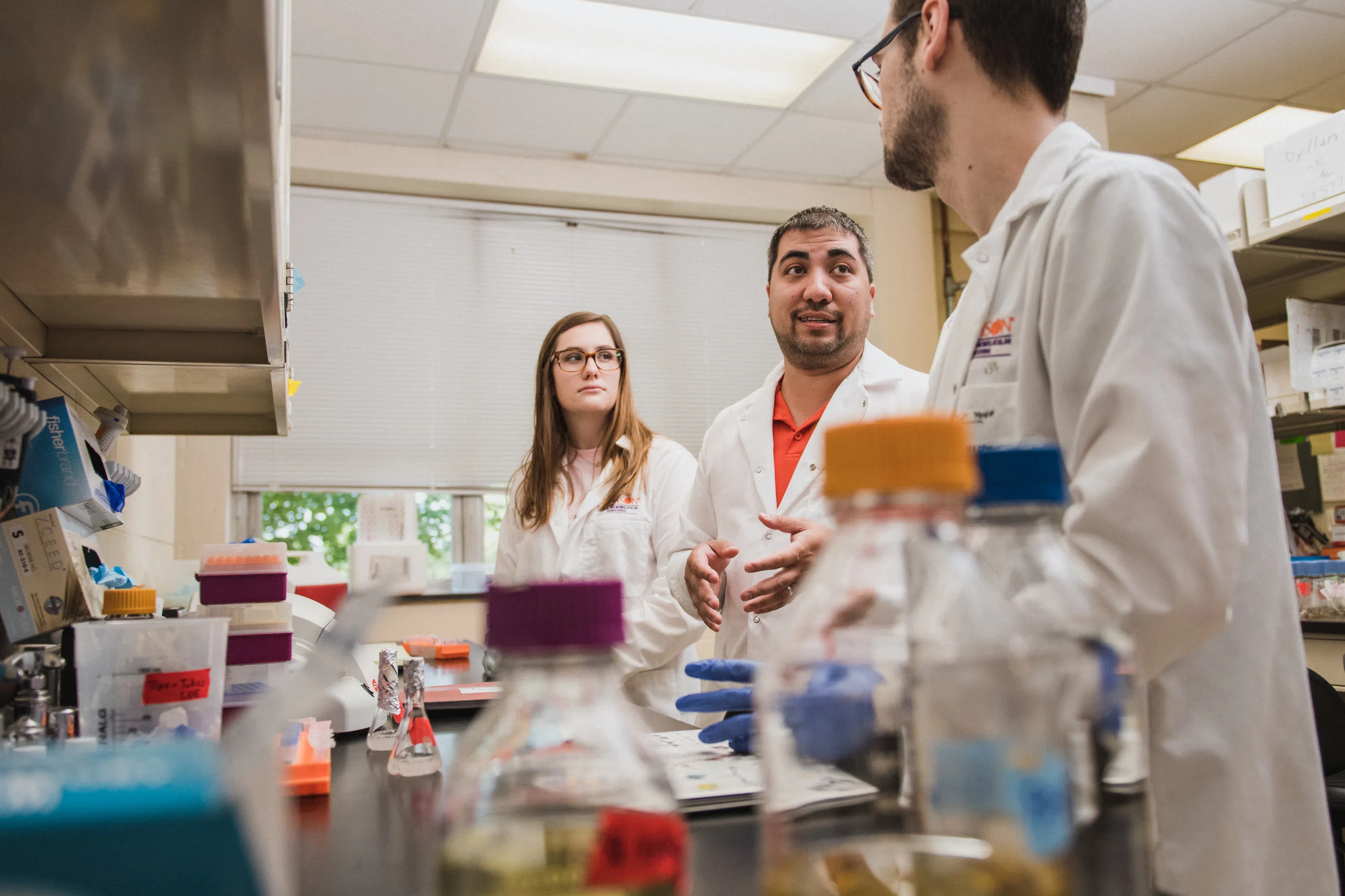 Chemical Engineering professor Mark Blenner works in the lab with two students.