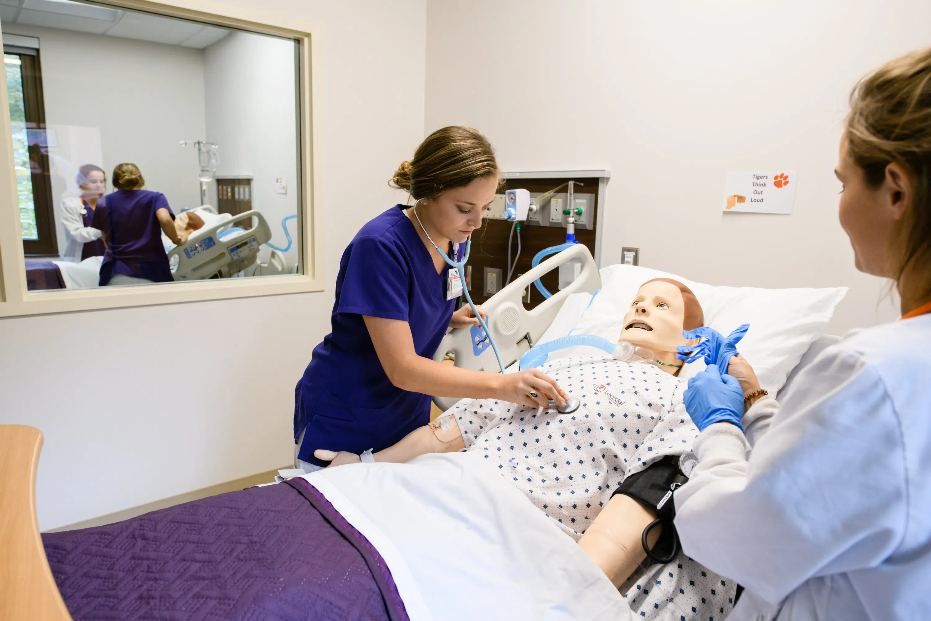A Nursing student works with a fake patient in the Nursing Simulation Lab in Edwards Hall.