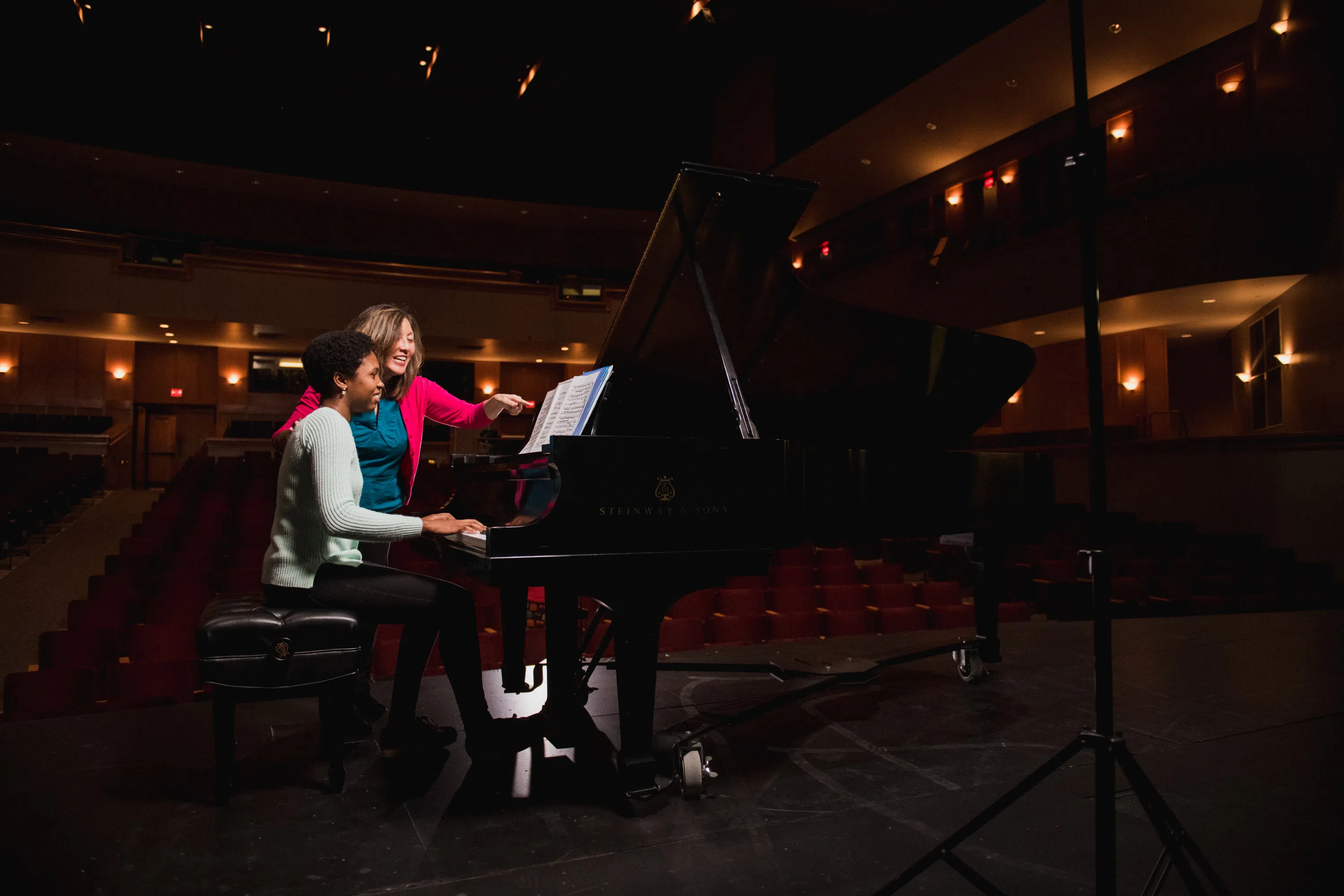 Performing Arts student Piper Starnes plays the piano with her professors in the Brooks Center Theater.