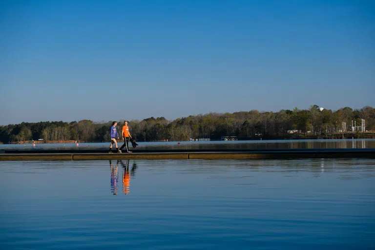 Students walk out on a dock on Lake Hartwell.