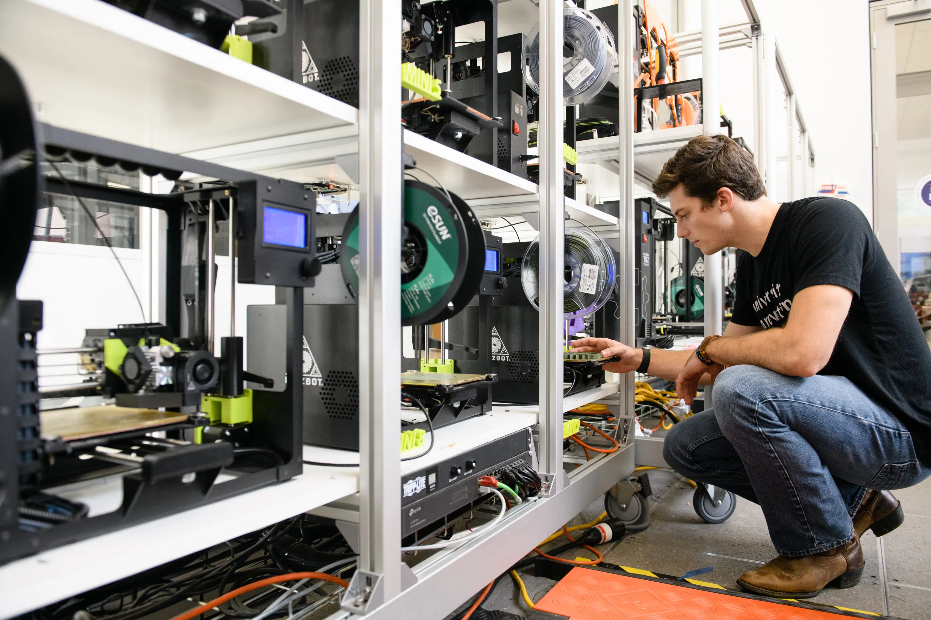 Student Gabriel Herman works with equipment in the Makerspace in the Watt Center.