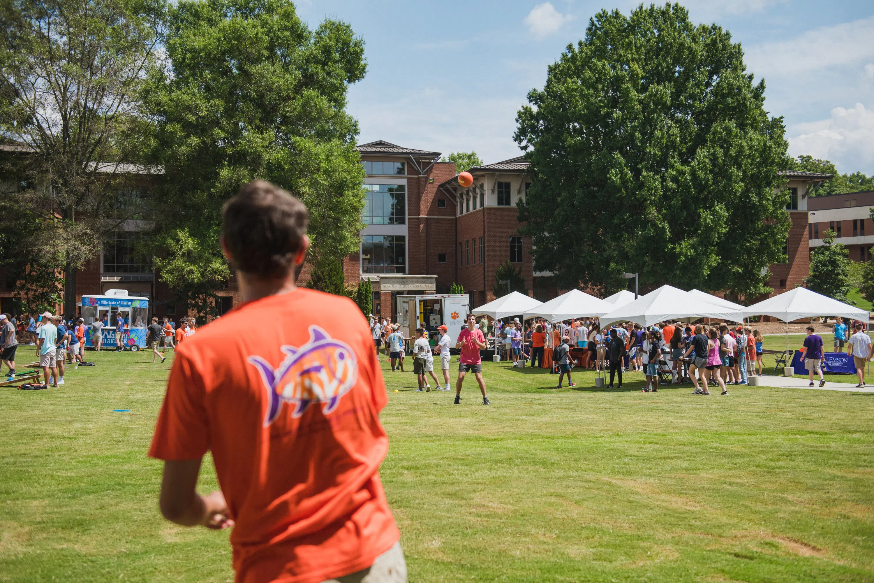 Groups of students participate in outdoor activities on the Watt Lawn.
