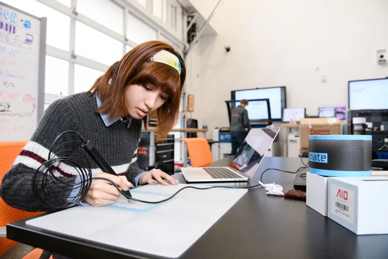 Art student Jiawei Ding works in the Watt Center Makerspace.