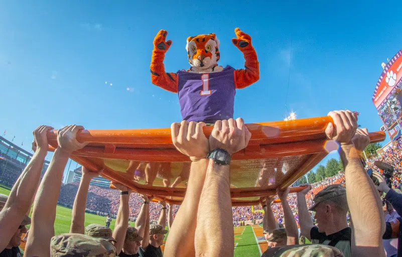 The Tiger mascot poses on the push-up plank during a football game.