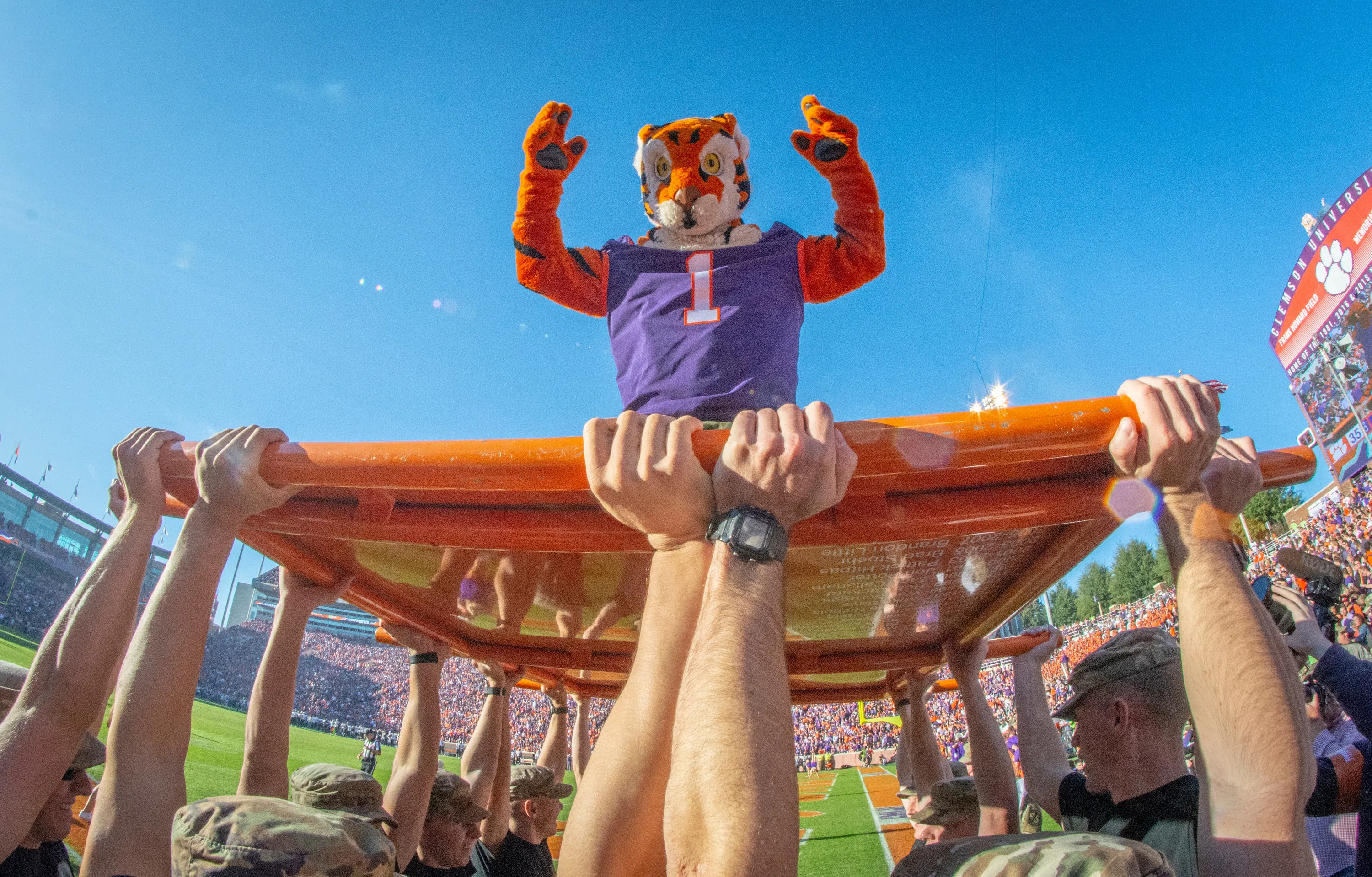 The Tiger mascot poses on the push-up plank during a football game.