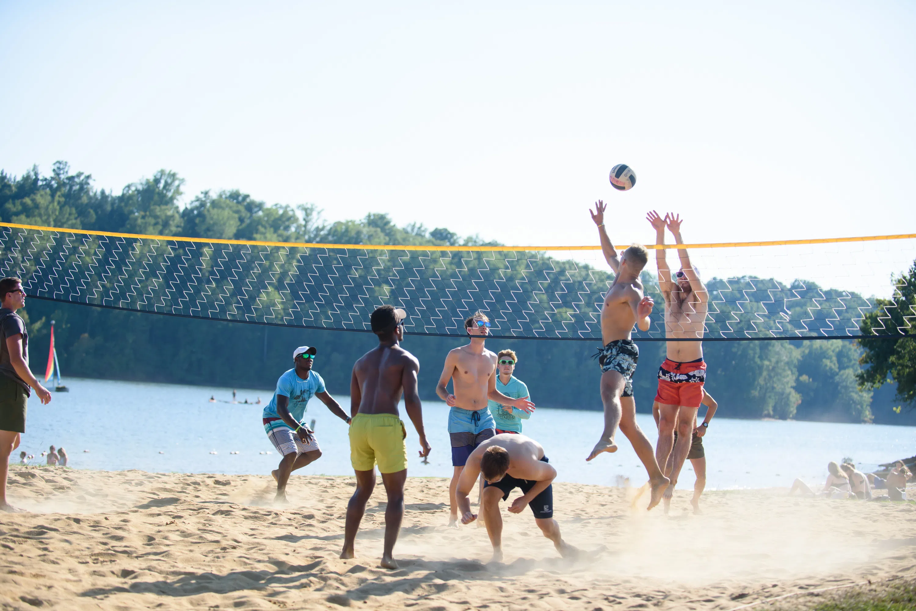 Clemson students play volleyball on the beach by Lake Hartwell. 