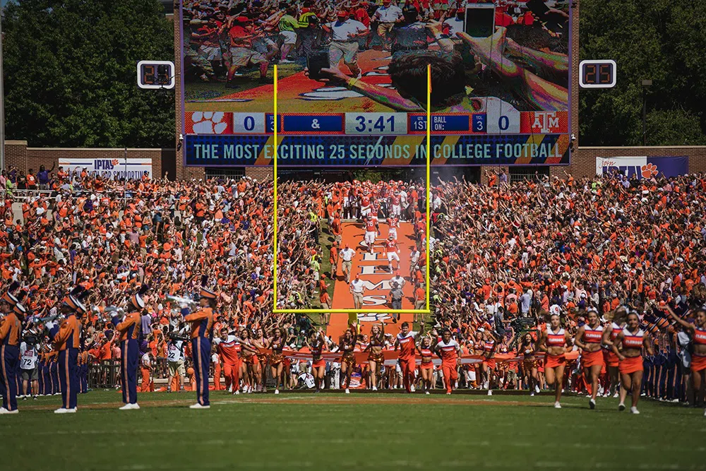 The Clemson Tigers football team runs down the hill into Death Valley.