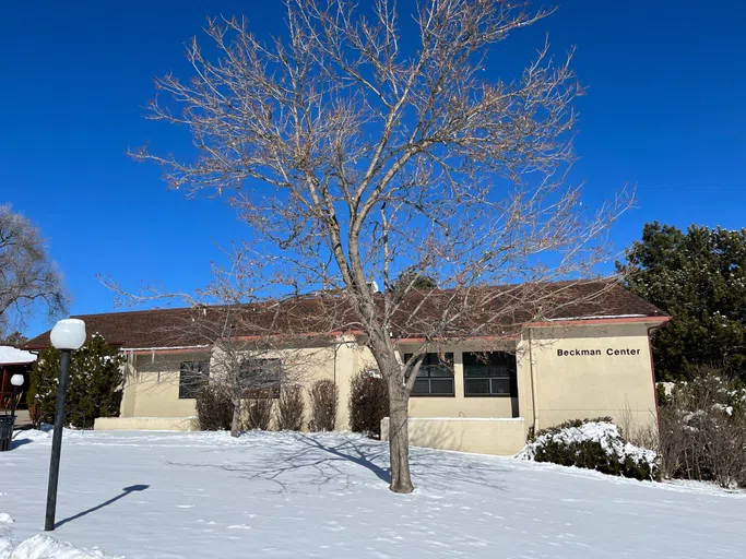 Front of Beckman with a large tree and snow