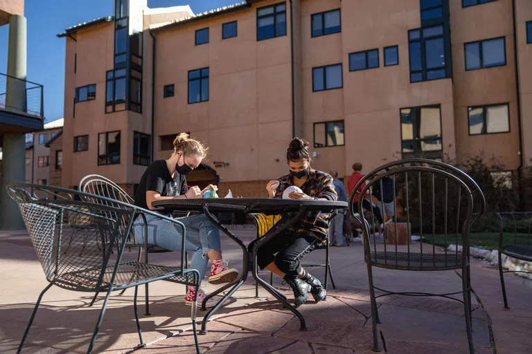 Students seated outside on Alumni Plaza