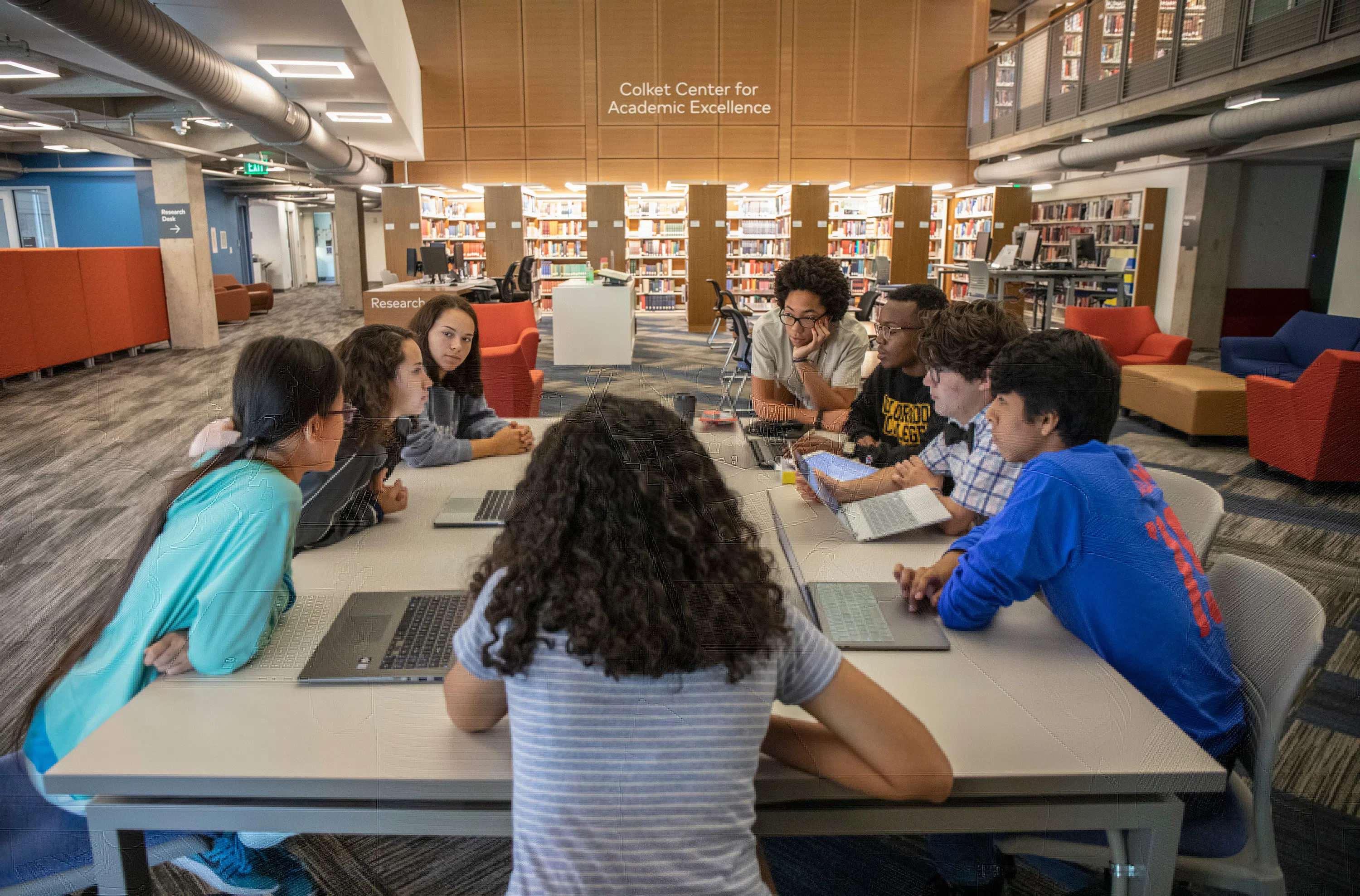 Students gathered around a table in Tutt Library