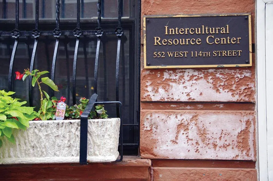 A plque reads "Intercultural Resource Center" on the right side of the screen with a window and flowerbox on the left side.
