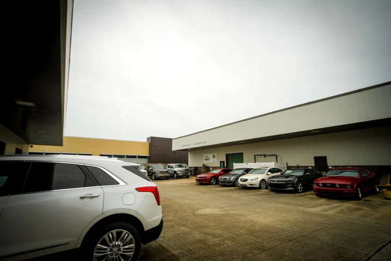 open space with cars in front of a building in the distance