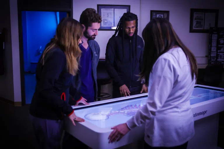 healthcare students around digital radiologic tech table