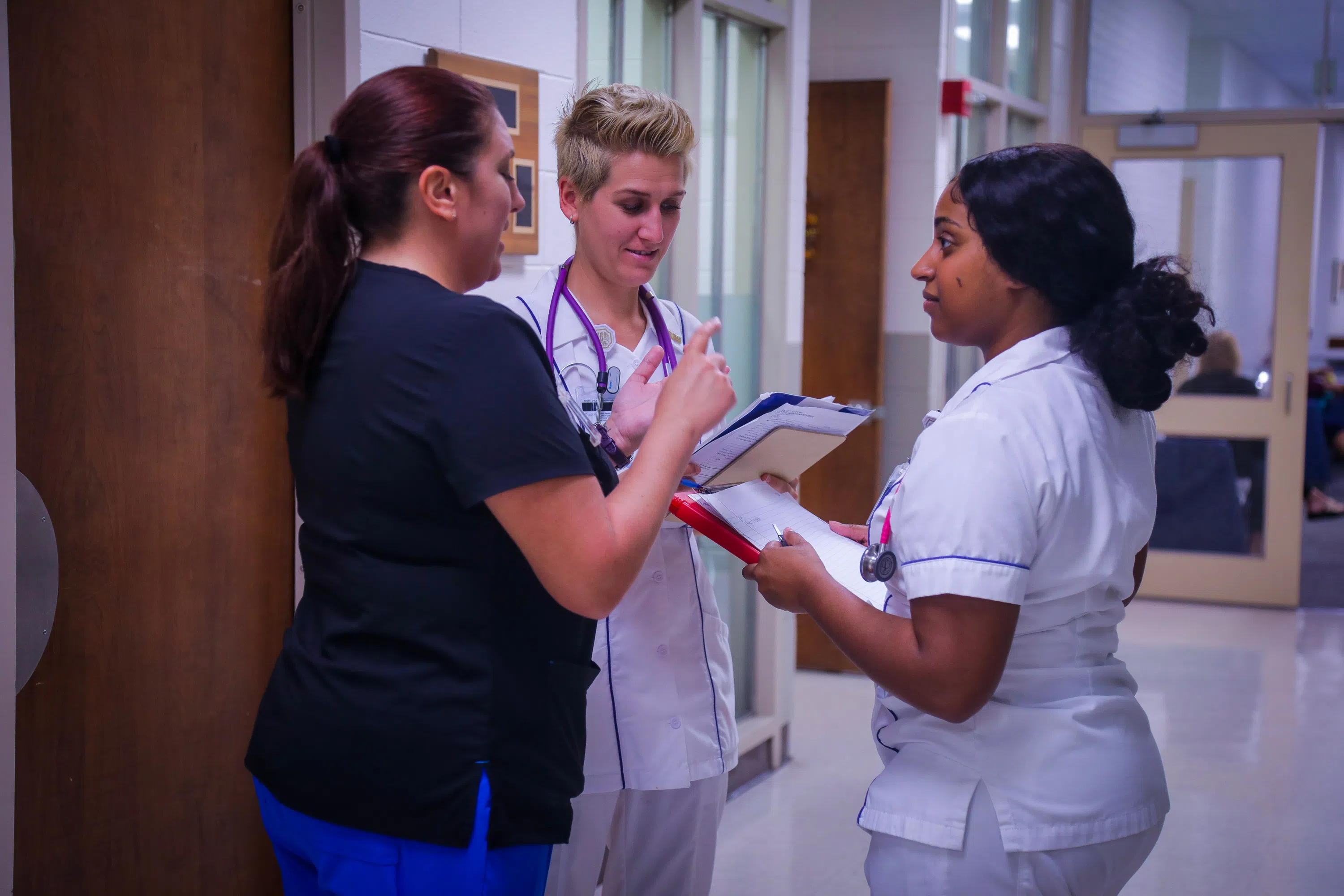 3 nursing students talking with each other