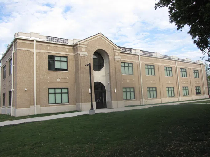 front of building - beige with archway at doorway and windows - 2 floors