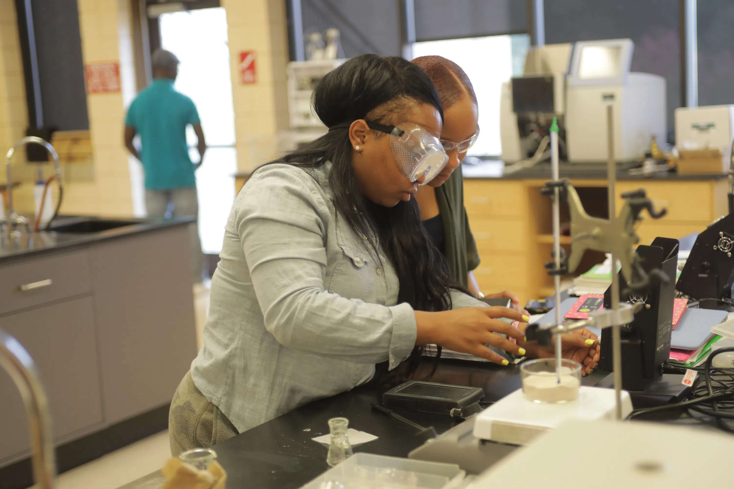 students wearing safety goggles working on lab project