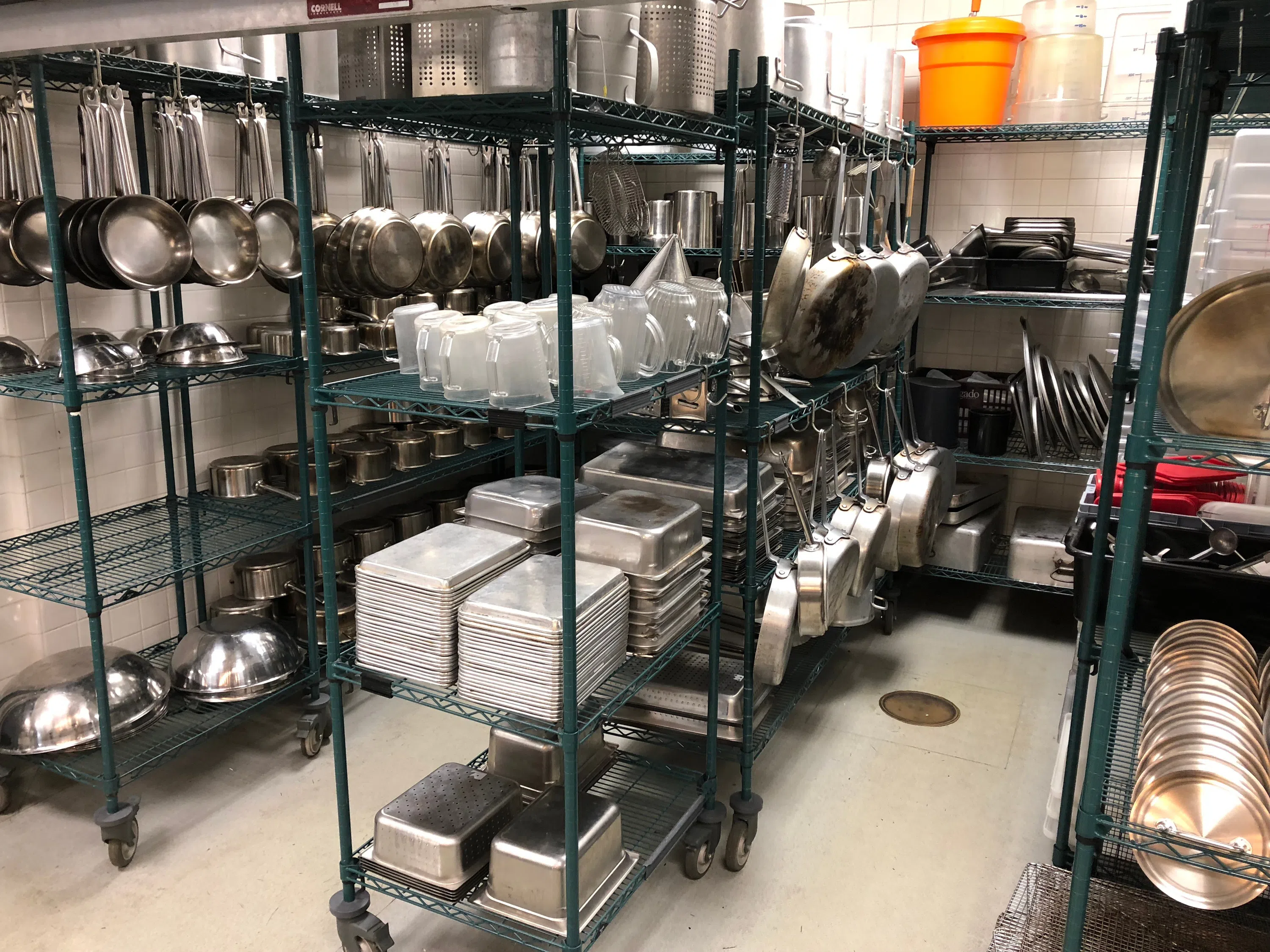 cookware hanging and on shelves in storage room