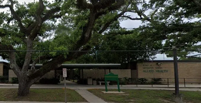 front of building from a street view with trees in front