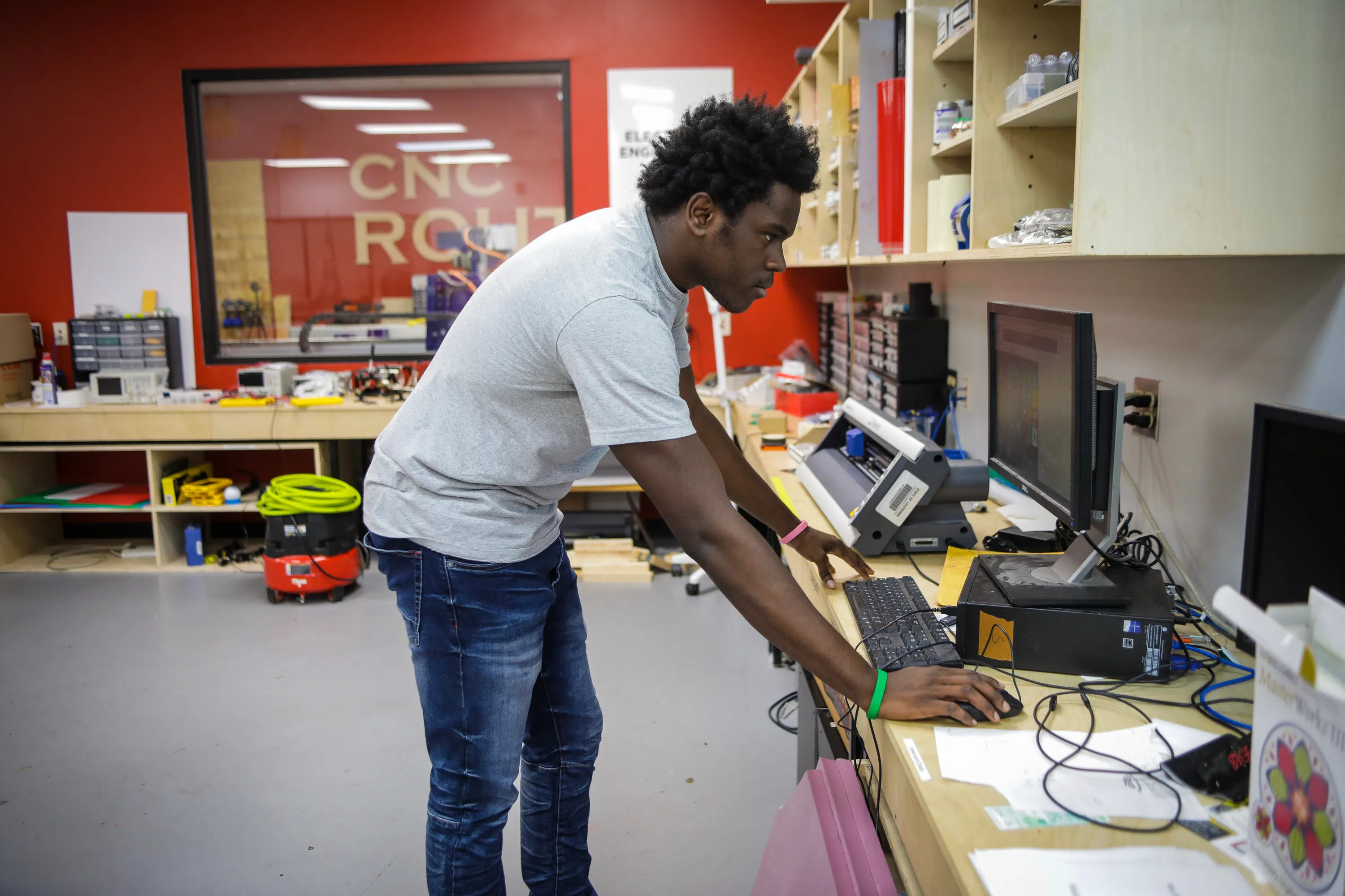 student working at vinyl cutter