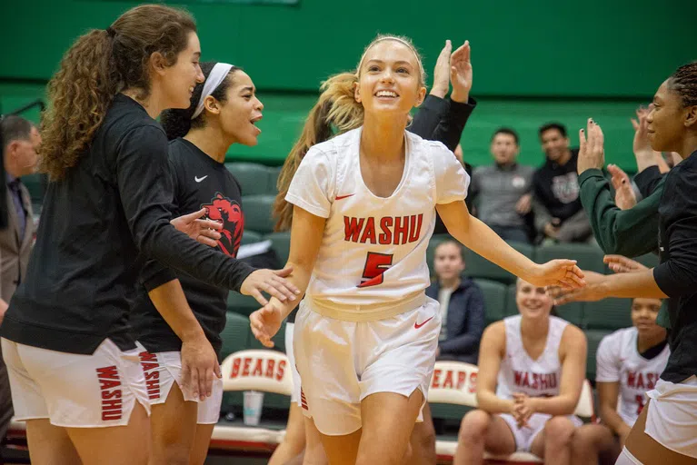 A Women's Basketball players runs out on to the court