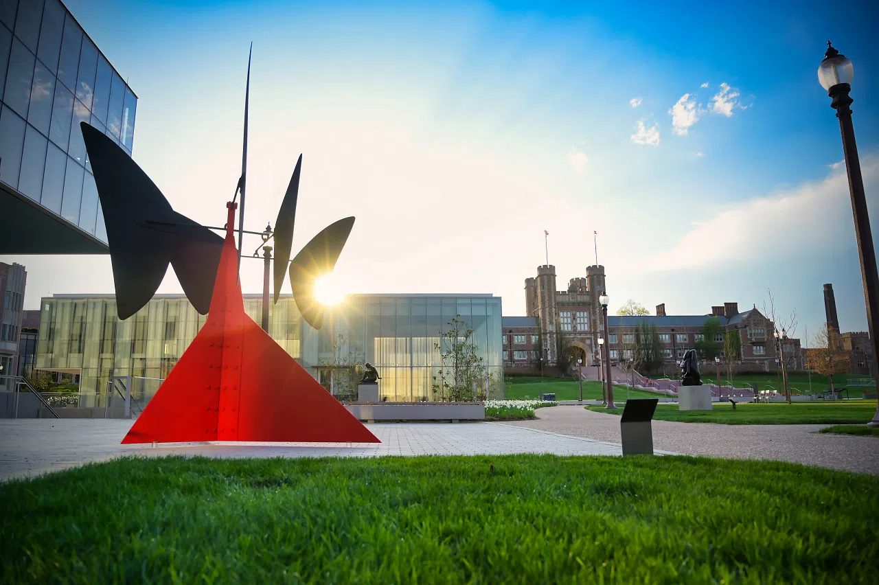 A sculpture sitting outside of Kemper, with Brookings Hall in the distance