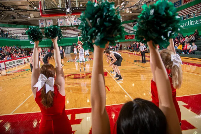 Cheerleaders performing at a basketball game