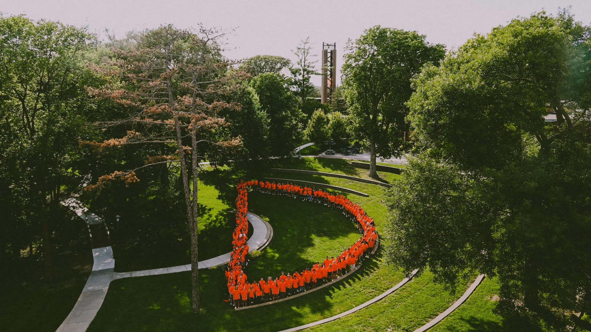 The class of 2027 stand in Cassel Theatre in the shape of the capital letter D.