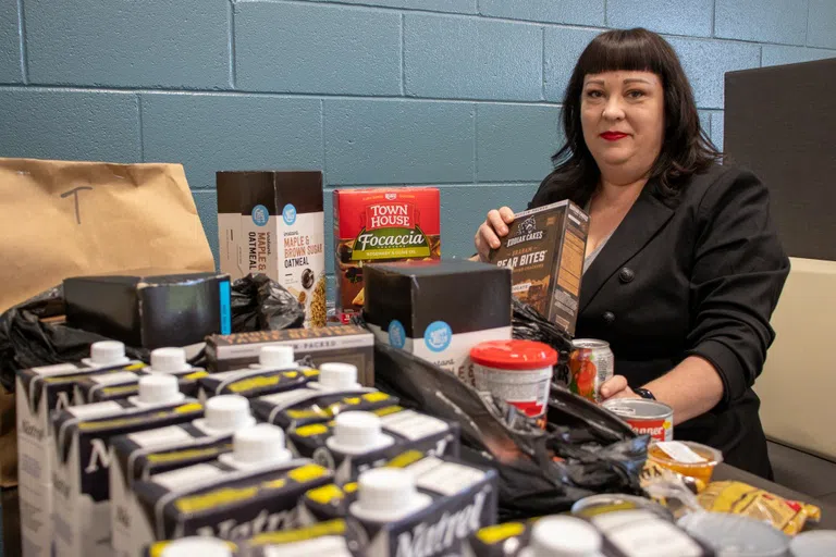 Professor Deena Lilygren packs groceries in The Lunch Box to send home with students.