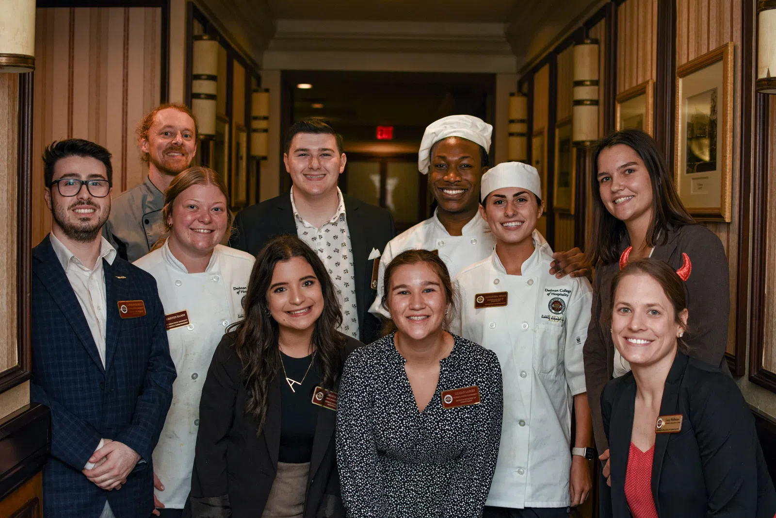 This photo features 10 students smiling at the camera after completing their portion of the Little Dinner Series.