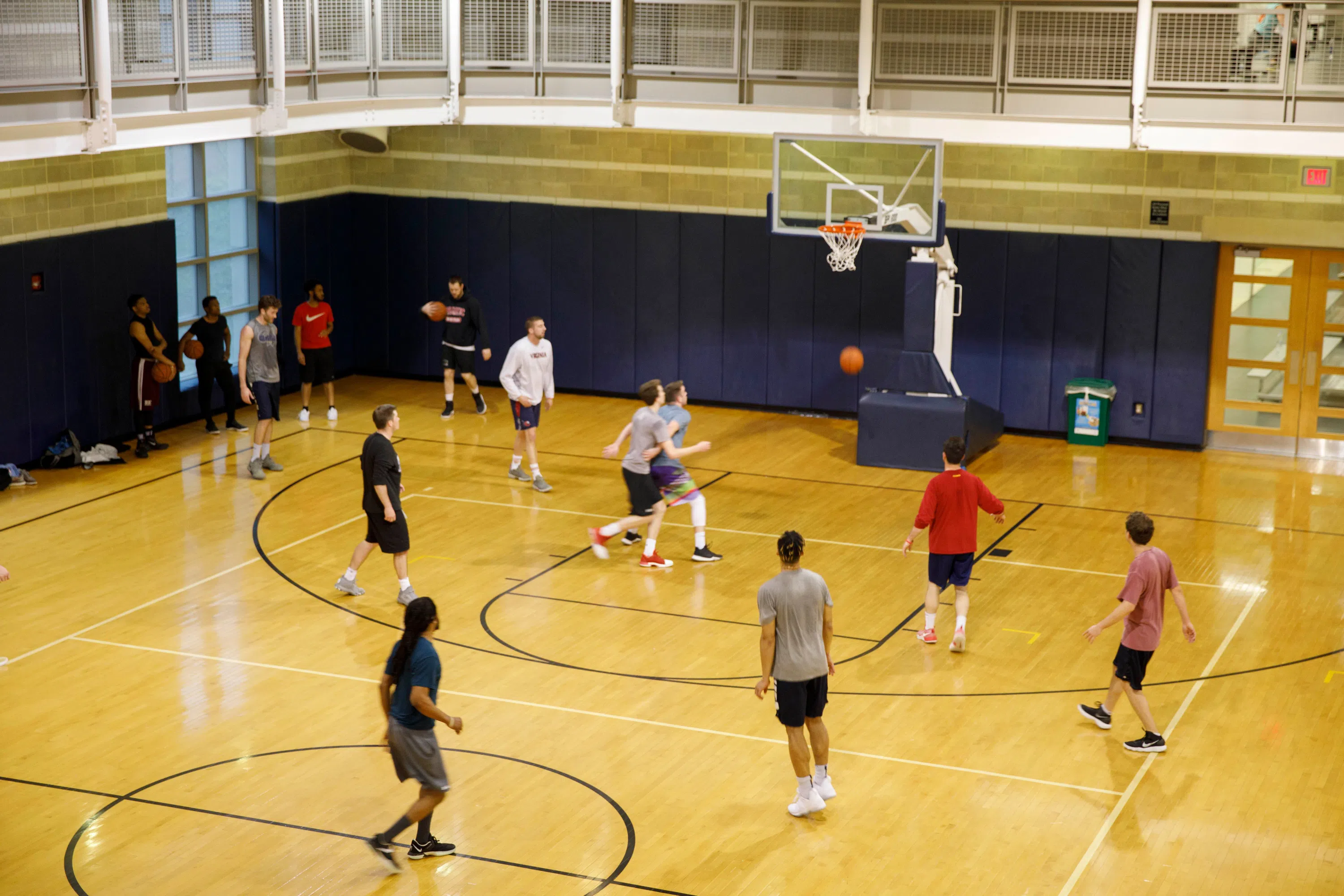 People playing basketball in the gym. 