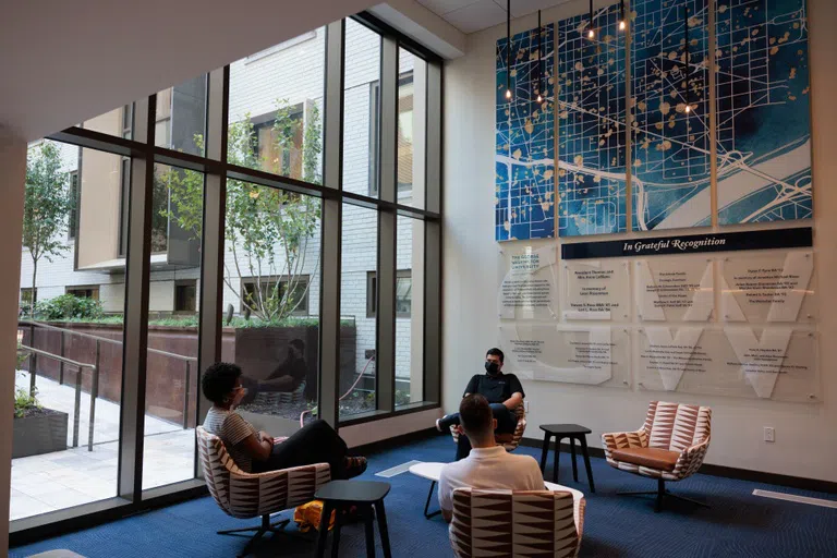 Students sitting in a community space in Thurston Hall