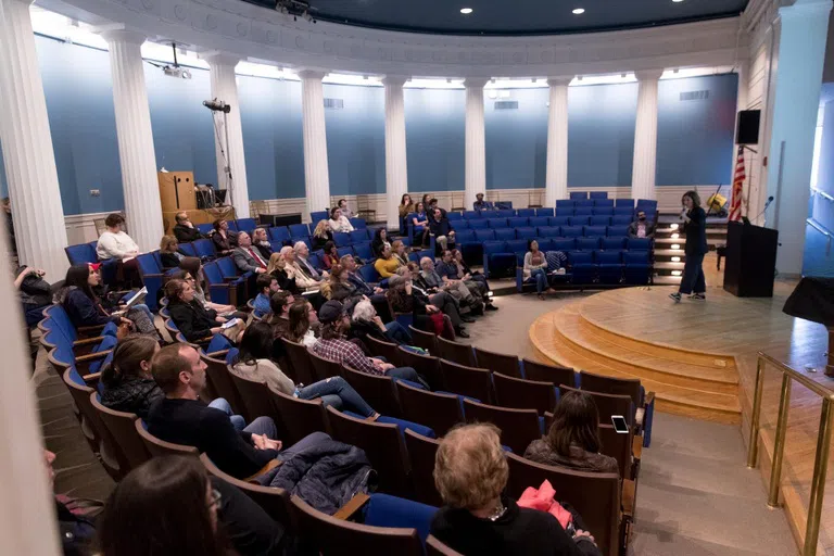 A national illustrator speaking to a community crowd in the Flagg Building Auditorium