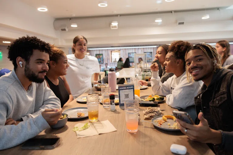 A group of students eating a meal together in Thurston Dining Hall.