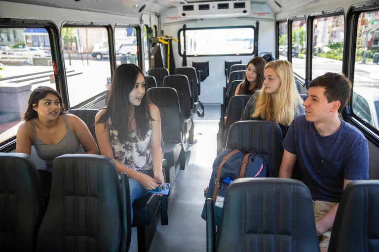 Students talking while riding the bus