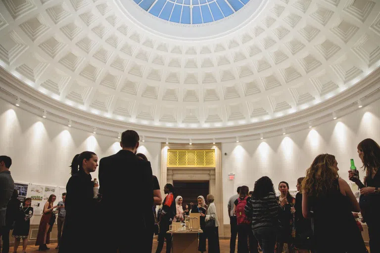 Students attend the NEXT exhibition of student art in the Flagg Building Rotunda