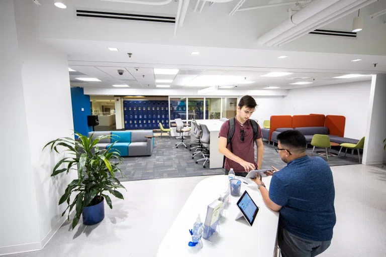 A student receiving help from staff in the Student Services Hub.