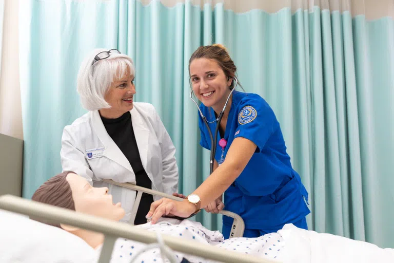 Nursing student practices on mock patient 